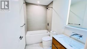 Toronto (Annex) condo for rent - A modern realtor office with a reception desk and a red car parked outside.