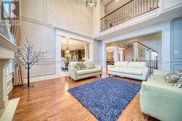 Aurora (Aurora Estates) apartment for rent - A large open living room with white furniture and a blue rug.