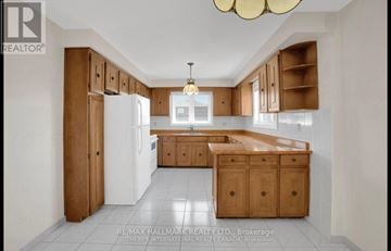 Richmond Hill (Mill Pond) apartment for rent - A kitchen with wooden cabinets and a white refrigerator.