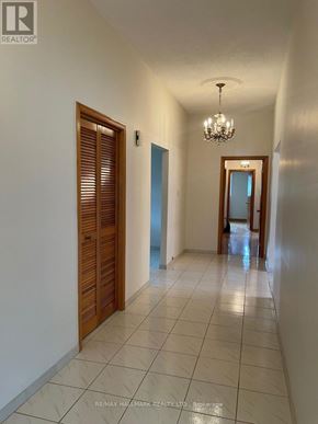 Richmond Hill (Mill Pond) apartment for rent - A hallway with a chandelier and a door on the right.