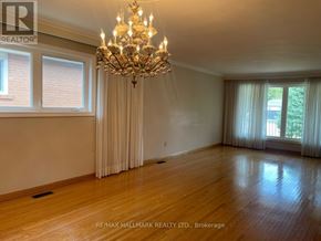 Richmond Hill (Mill Pond) apartment for rent - A large, well-lit room with a chandelier and hardwood floors.