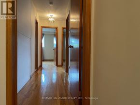 Richmond Hill (Mill Pond) apartment for rent - A hallway with wooden floors and white walls.