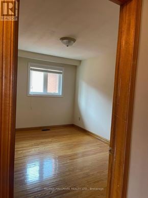 Richmond Hill (Mill Pond) apartment for rent - A room with a window and wooden floors.