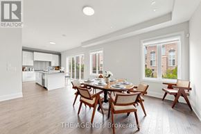 Vaughan (Patterson) apartment for rent - A dining room with a table set for six with a view of a brick building outside the window.