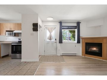 Gatineau (Hull) condo for rent - A modern kitchen with a stainless steel oven and a fireplace in the living room.