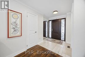 Mississauga (Erin Mills) apartment for rent - A hallway with a framed artwork on the wall and a brokerage sign on the floor.