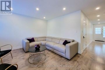 Oakville (Wm Westmount) townhouse for rent - A living room with a white couch and a glass coffee table.