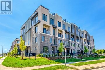 Mississauga (Erin Mills) townhouse for rent - A modern apartment building with a clear blue sky in the background.