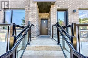 Mississauga (Erin Mills) townhouse for rent - A brick building with a glass railing and a door.