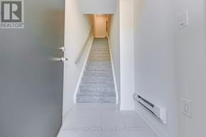Mississauga (Erin Mills) townhouse for rent - A hallway with a staircase leading to a door.
