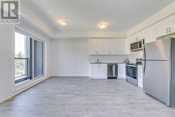Mississauga (Erin Mills) townhouse for rent - A spacious kitchen with white cabinets and stainless steel appliances.