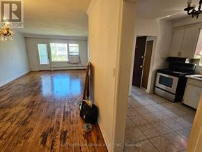 Toronto (Yorkdale-Glen Park) triplex for rent - A room with a guitar leaning against the wall.