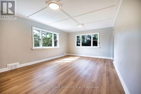 Peterborough (Northcrest Ward 5) apartment for rent - A room with wooden floors and white walls.