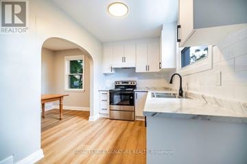 Peterborough (Northcrest Ward 5) apartment for rent - A modern kitchen with white cabinets and a marble countertop.