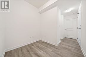 Hamilton (Waterdown) condo for rent - A white room with a door and a wooden floor.