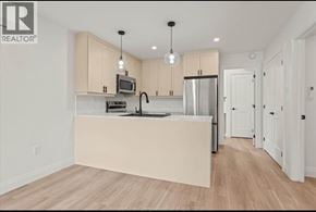 Windsor apartment for rent - A kitchen with wooden floors and white walls.