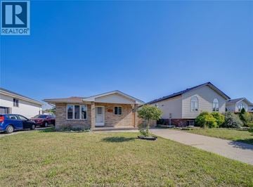 Windsor apartment for rent - A house with a car parked in front is for sale.