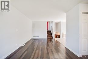 Windsor apartment for rent - A long hallway with wood floors and white walls.