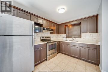 Windsor apartment for rent - A kitchen with brown cabinets and a white refrigerator.