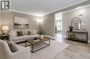 St. Catharines apartment for rent - A living room with a white sofa, a coffee table, and a painting on the wall.