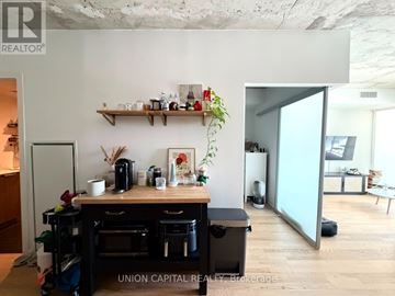 Toronto (Waterfront Communities) condo for rent - A hallway with a broker standing at the end.