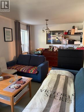 Toronto (Parkwoods-Donalda) condo for rent - A living room with a sofa, coffee table, and a dresser.
