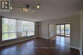 Toronto (Church-Yonge Corridor) condo for rent - A spacious room with wooden floors and sliding glass doors leading to a backyard.