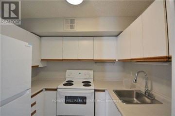 Toronto (Church-Yonge Corridor) condo for rent - A white stove and sink in a small kitchen.