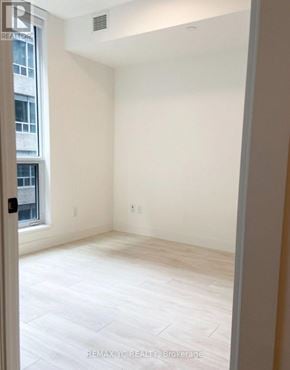 Toronto (Waterfront Communities) condo for rent - A white room with a window and a door.