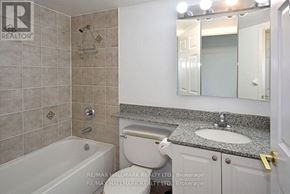Toronto (Willowdale West) condo for rent - A bathroom with a tub, toilet, and sink.
