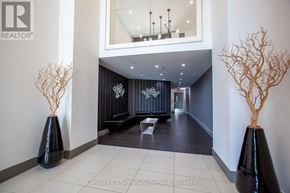 Toronto (Moss Park) condo for rent - A hallway with a mirror, two vases, and a bench.