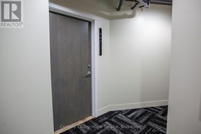 Toronto (Moss Park) condo for rent - A door in a hallway with a sign on the wall.