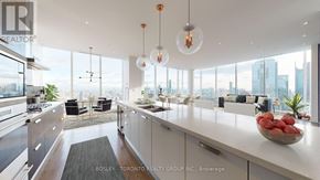 Toronto (Waterfront Communities) condo for rent - A modern kitchen with a view of the city.