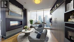 Toronto (Waterfront Communities) condo for rent - A living room with a grey couch and a fireplace.