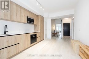 Toronto (Mount Pleasant West) condo for rent - A modern kitchen with wooden cabinets and a black oven.