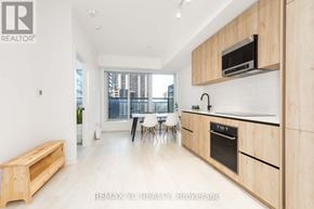 Toronto (Mount Pleasant West) condo for rent - A modern kitchen with wooden cabinets and a bench.
