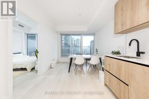 Toronto (Mount Pleasant West) condo for rent - A modern kitchen with wooden cabinets and a black faucet.