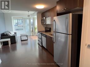 Toronto (Niagara) condo for rent - A kitchen with a refrigerator, microwave, and oven.