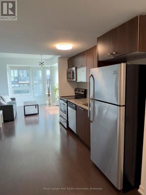 Toronto (Niagara) condo for rent - A kitchen with a refrigerator, oven, and sink.