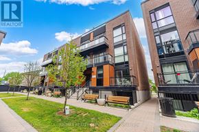 Vaughan (Vaughan Grove) townhouse for rent - A modern apartment complex with a well-maintained lawn and benches.