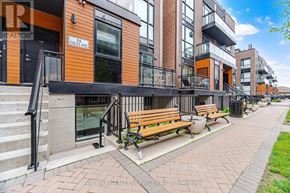 Vaughan (Vaughan Grove) townhouse for rent - A street view of a residential area with apartment buildings and benches.