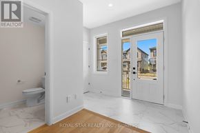 Ottawa apartment for rent - A white bathroom with a toilet and a window.