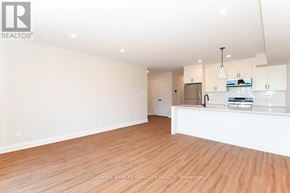 Ottawa apartment for rent - A spacious, empty room with wooden floors and white walls.