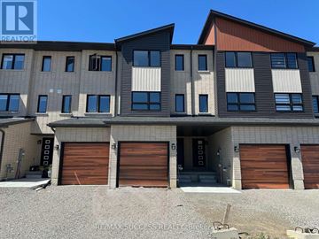 Barrie townhouse for rent - A multi-story building with a mix of beige and brown panels, and dark brown garage doors.