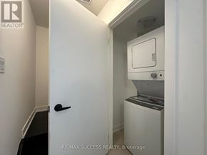 Barrie townhouse for rent - A white door with a black handle is open to reveal a small white cabinet with a glass window.