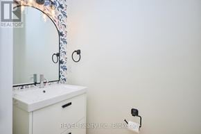 Niagara Falls (Ascot) apartment for rent - A white bathroom sink under a mirror with a floral design.