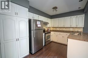 Windsor townhouse for rent - A kitchen with white cabinets and a refrigerator.