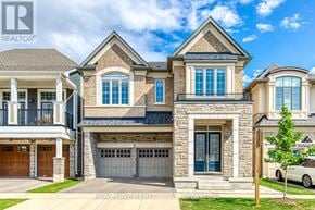 Oakville (Go Glenorchy) apartment for rent - A large, multi-story house with a stone facade and a garage door.
