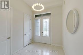Oakville (Go Glenorchy) apartment for rent - A white hallway with a chandelier and a mirror.