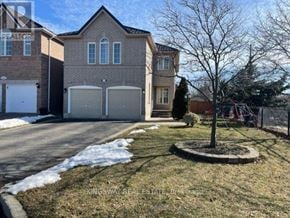 Mississauga (Meadowvale) apartment for rent - A house with a tree in front of it.